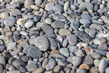 Stone pebbles on the seashore as an abstract background