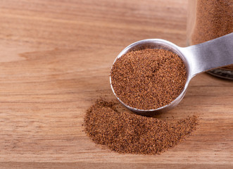 Ground Allspice on a Wooden Table