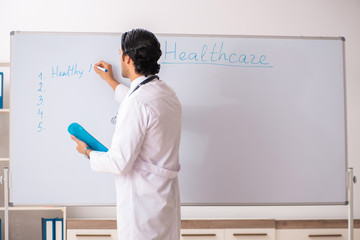 Young doctor in front of whiteboard 
