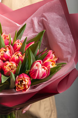 a huge bouquet of fresh delicate pink tulips in a gift box
