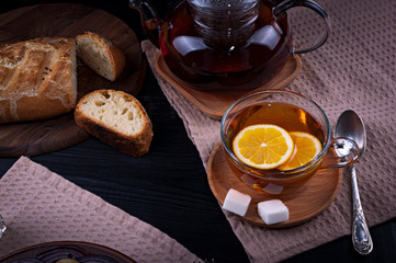 Hot tea with lemon. Pleasant drink with sugar and lemon