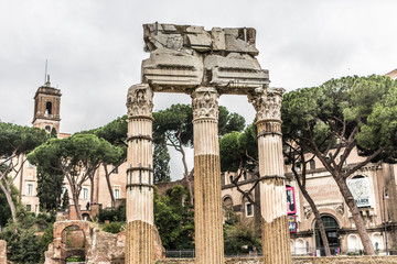 ROME, ITALY - November, 2018: Tourists in the Roman Forum at Temple of Saturn against Arch of...