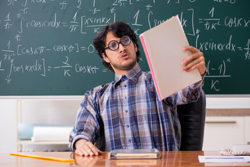 Funny male math teacher in the classroom 