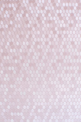 Texture of artificial radiant skin with honeycomb perforation. Abstract background, defocus.