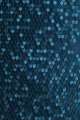 Texture of artificial radiant skin with honeycomb perforation. Abstract background, defocus.