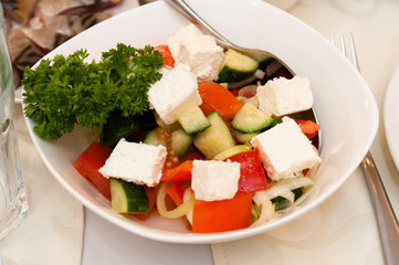 Festive delicious salad of mozzarella, tomato, olive and cucumber
