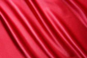 Fototapeta na wymiar red satin fabric with large folds, as background