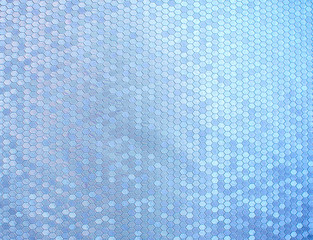 Texture of artificial radiant skin with honeycomb perforation. Abstract background, defocus.