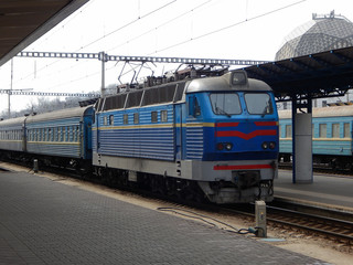 Fototapeta na wymiar Electric Train Arrival To Platform Of Passenger Railway Station 