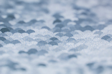 Texture fabric with shiny round sequins. Abstract background, defocus.