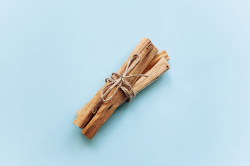 A set of wooden sticks Palo Santo on a blue background. They are used in aromatherapy and religious rites and meditations.