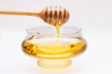 Fototapeta na wymiar Honey pot and dipper isolated on white background