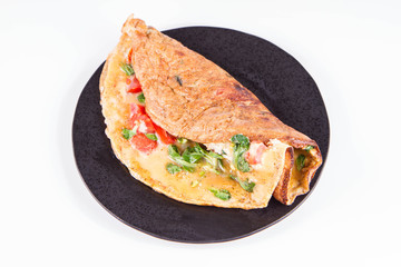 Omelette with tomatoes and fresh corn salad on a white background
