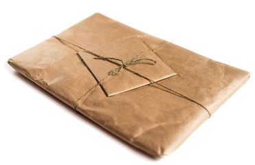 Package wrapped in craft paper on a white background.