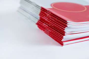 Pile of advertising magazines on a white background.