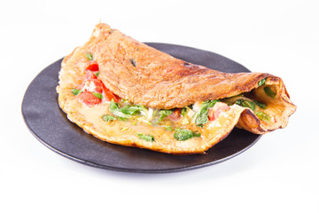 Omelette with tomatoes and fresh corn salad on a white background