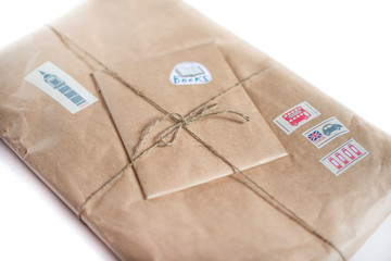 Package wrapped in craft paper on a white background.