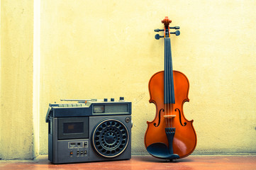 Wooden violin with old style radio,still life.