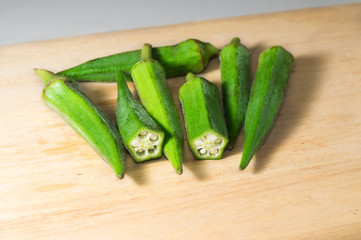 Fresh okra on cutting board.