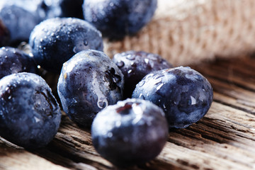Fresh raw blueberries on wooden background close up