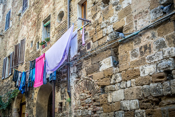 Urban landscape. Linen is dried on a rope. San Gimignano, Tuscany, Italy