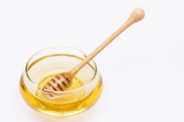 Honey pot and dipper isolated on white background, copy text