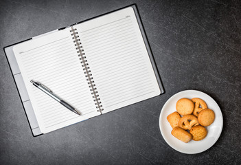 Cookie and Diary book  on black background.