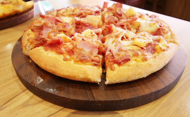 pizza served at restaurant on handled wooden board