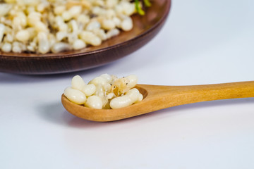 Fresh Red ant eggs are larvae of ants in wood spoon .