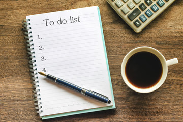 To Do List text on book note with cup of coffee, pen and smartphone.