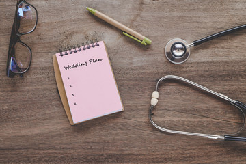 Check list for health text on book note with stethoscope on wood.