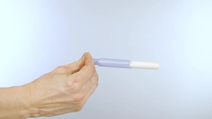Close up demonstration of how a tampon works