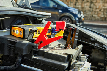 Selective focus of charging a car with electricity through cables from a compact battery