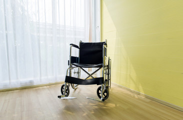Empty wheel chair for patient in room at hospital