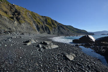 Fototapeta premium image of black sand with stones