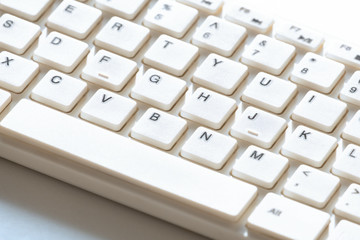 White keyboard for computer. Close-up. Background for design on the topic of information technology.