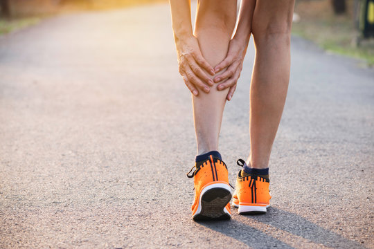 Woman walking on the road get accident on her legs the image is for health concept.