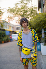 Portrait of young rebellious man standing in the streets outdoors