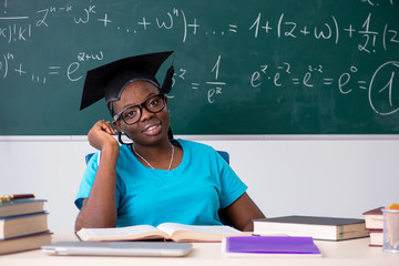 Black female student in front of chalkboard  