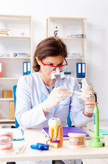 Female doctor working on new teeth implant 