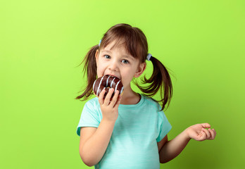 Four-year-old girl eat donut.