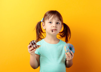 Four-year-old girl eat donut.