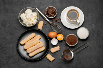 Ingredients for cooking tiramisu - Savoiardi biscuit cookies, mascarpone, cream, sugar, cocoa, coffee and egg