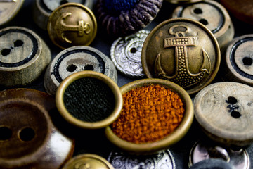 Collection of vintage clothing buttons. Dark stone background, grunge photo.
