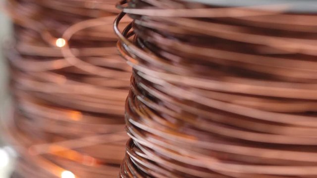 Close up of the bare bright copper wire on the spool, Rack focus, Two shot