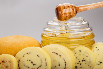 Honey and cheese closeup with focus on sticky honey.
