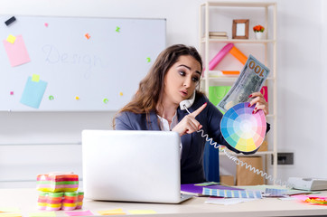 Young female designer working in the office 