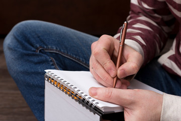 Closeup male writing in notebook. Concept in education and knowledge