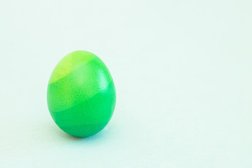 ombre colored green easter egg with soft background