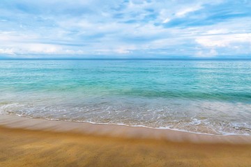 Panorama hdr image of Andaman sea beach at tropical summer island in morning sunrise, free space. Seascape overcast with white cloudy blue sky before rain storm during midday light in stormy season.